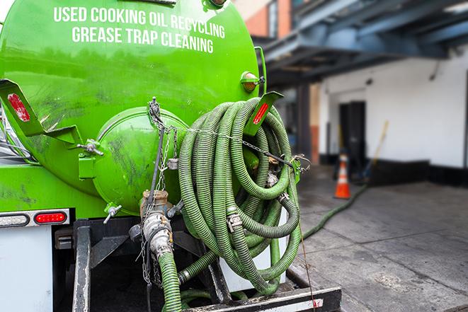 a grease trap pumping service in action at a commercial building in Escondido